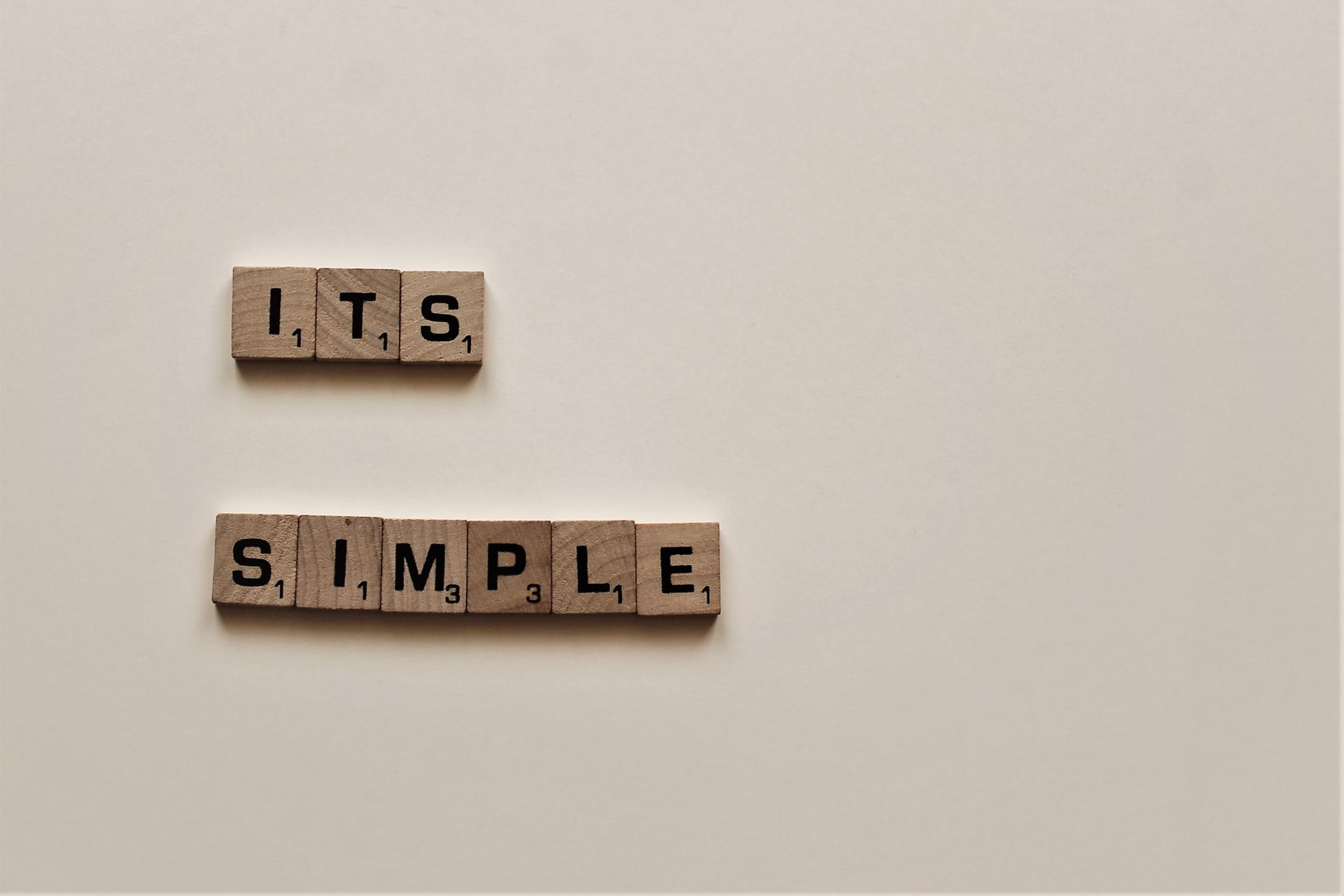 Wooden cubes spelling out "It's simple"